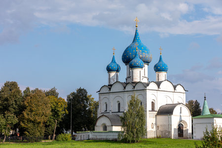 View of the Cathedral of the Nativity of the Blessed Virgin in the Suzdal Kremlin. Blue domes with gilded crosses and stars. Religion concept. Suzdal, Vladimir region, Russia - SEPTEMBER 12, 2021のeditorial素材
