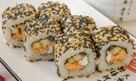 Sushi rolls, on a plate with hieroglyphicsのeditorial素材