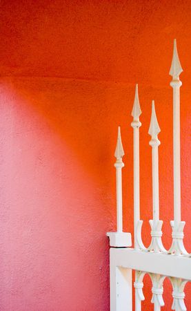 close-up of a white gate against a red wallの写真素材