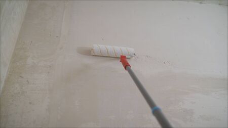 Brick wall repair with putty. Applying a primer on a brick wall. primer on the brick wall with a roller.の写真素材