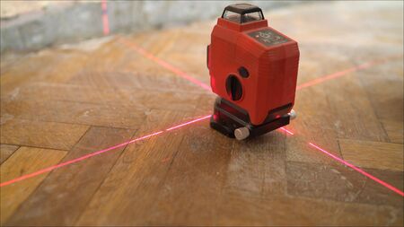 Setting the laser level. Apartment renovation. A laser level machine during measurement work in a...
