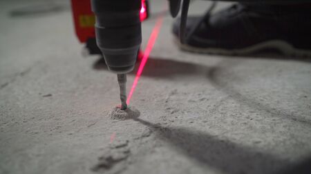 Worker drills a concrete floor. Drill, concrete floor, workerの写真素材