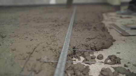 Construction worker Concrete pouring during commercial concreting floors of building in construction site and Civil Engineer. The process of filling and leveling floors.の写真素材