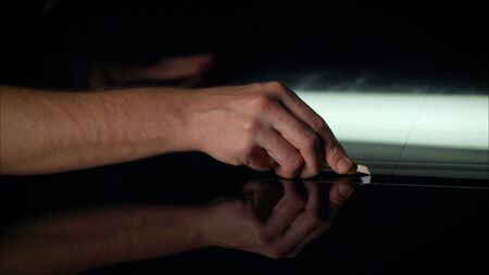 The protective film is removed from the machine with a paper knife. Car wrapping specialists...