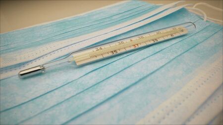 blue disposable face masks on wooden board medical concept. Coronavirus masks. Virus Protection...