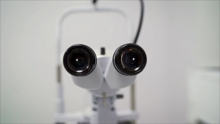 Apparatus for the diagnosis of vision. Spacious case. Tall complicated device for intense ophthalmology diagnoses made of metal and plasticの写真素材