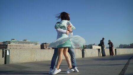 A girl and a guy dance a Spanish dance on the street to live music. Musicians play outside, and passers-by danceの写真素材