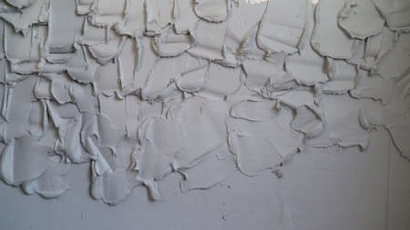 A layer of wet mortar of finishing putty, leveling the wall, with gypsum plaster, building the...