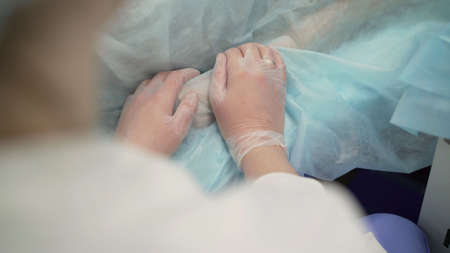 Helping Hand During the Sars-Cov-2 Pandemic. The doctor holds the patients hand during the...