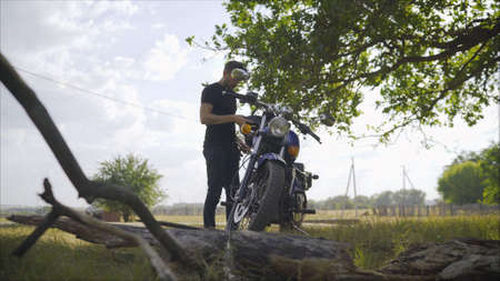 Motorcyclist in nature. Motorcyclist on green grass off road, enduro, extreme sport, active lifestyle, adventure touring concept, enduro outdoorの写真素材