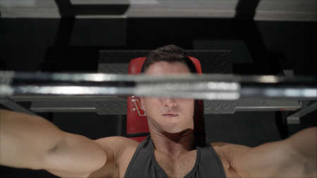 A guy with a beautiful figure shakes his chest in the gym. Shakes his chest in the gym on the...