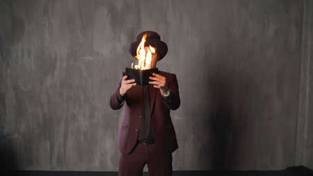 The man opens his wallet. Bankruptcy, poverty concept. Money is burning. The wizard burns his...