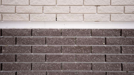 Brick wall. Texture of real wall. Wall in brown and white bricks.