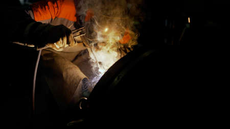 Industrial Worker welding steel. Welder at work. ndustrial Welder With Torch.の写真素材
