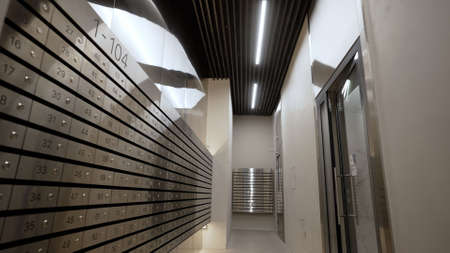 Modern entrance with mailboxes. Modern, new hall in a multi-storey building. Corridor with postboxes...