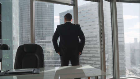 Managing director silhouette man examines company problems. Successful man in a suit on the...