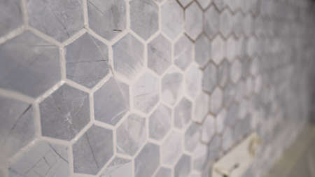 Interior Design Hexagon Marble Tile. A white wall with hexagon tiles for texture and background....