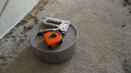 The damper tape lies in a roll. Gray tape for floor repair.