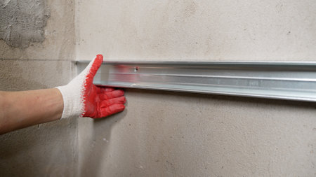 Laying ceramic tiles on the wall. Reinforcement for laying tiles in the bathroom on the wall.の写真素材