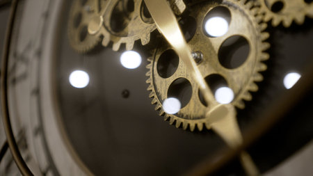 Clock gears and cogs in action. Wall clock with a mechanism, close-up. Clock mechanism, gears close-up. clockwork.の写真素材