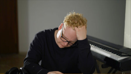 Handsome music composer working on new track. Inspired composer