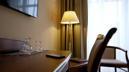 Table and chair in a hotel room. Workplace in the evening in the home room. Interior of a hotel room with a table and chair.の写真素材