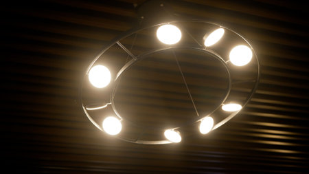 Round wooden chandelier with lamps included. Included round chandelier with light bulbs against the...