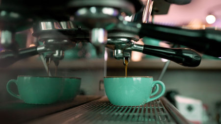 Cafe coffee service concept. Close-up of pouring espresso from a coffee machine. The coffee machine prepares coffee in a restaurant.の写真素材