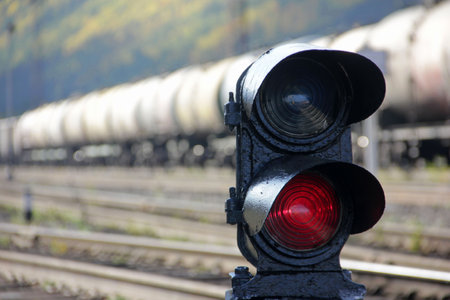 Traffic light with two sections on the railway tracks. Close-up of a traffic light against the...