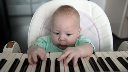 Adorable baby engaging with synthesizer keys in a playful musical montage.
