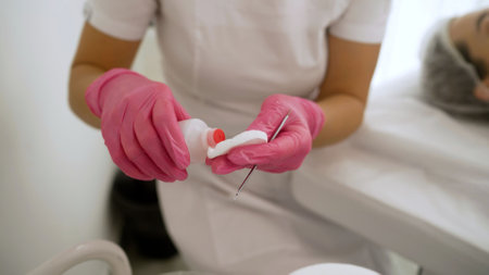 Beautician preparing disinfectant for cosmetology procedure.の写真素材