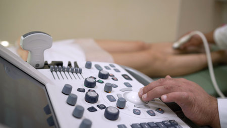 Doctor operating ultrasound scanner, conducting diagnostic procedure on patient's leg, focusing on innovative healthcare technologyの写真素材