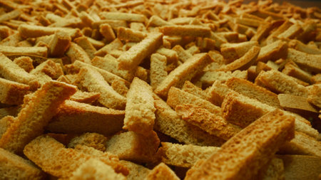 Automated equipment sorting and distributing crispy snack sticks into multiple sections for...