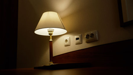Elegant table lamp illuminating hotel room