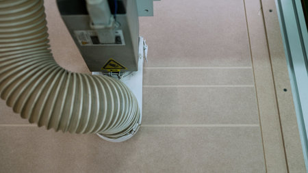 Automated cnc machine cutting grooves in a wood panel in a modern woodworking factory, demonstrating...