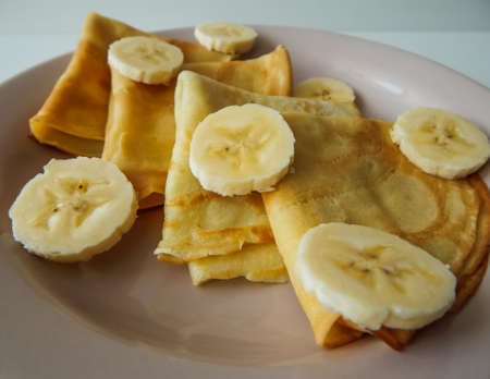 pancakes on a plate with banana slices