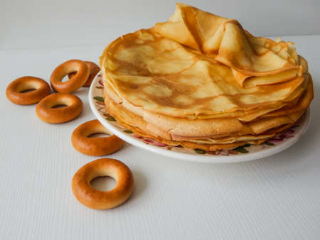 a stack of pancakes on a plate and donuts, Maslenitsaの写真素材