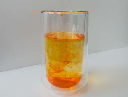 water in a glass colored with manganese, beautiful patternsの写真素材