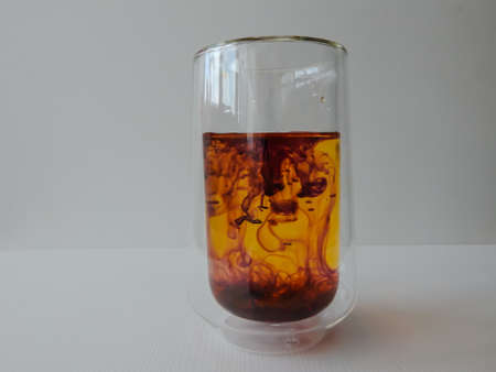water in a glass colored with manganese, beautiful patternsの写真素材
