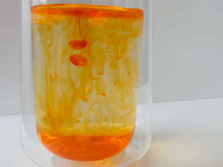 water in a glass colored with manganese, beautiful patternsの写真素材