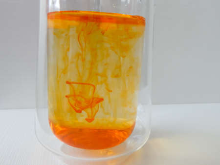 water in a glass colored with manganese, beautiful patternsの写真素材
