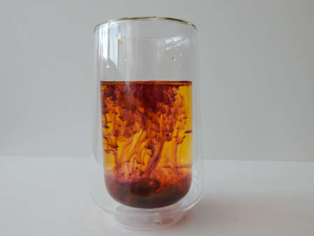 water in a glass colored with manganese, beautiful patternsの写真素材