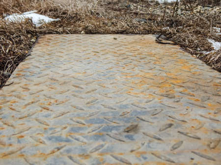 corrugated iron sheet lies on the grassの写真素材