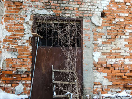 an old abandoned building built in 1957, iron door and stairs