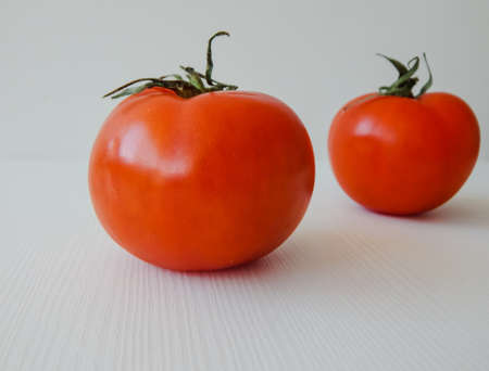 tomatoes, two pieces red on a light backgroundの写真素材