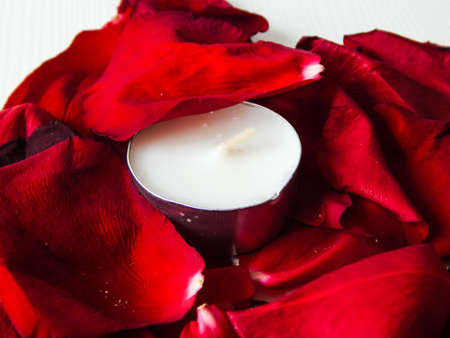 rose petals and a candle among themの写真素材