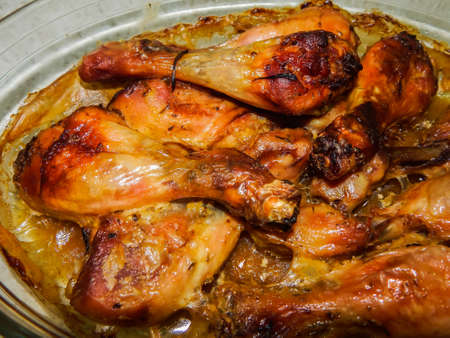baked chicken legs in a glass bowlの写真素材