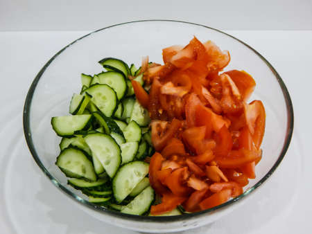 fresh tomato and cucumber saland in a glass bowl, vegetarianism, fastingの写真素材