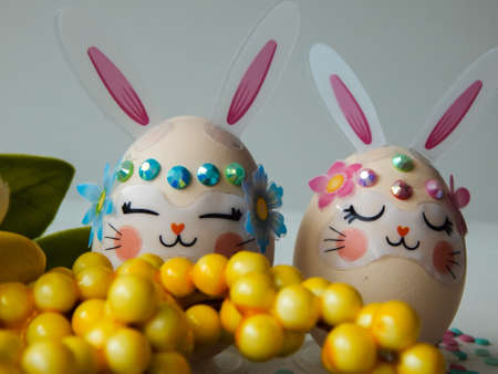 chicken eggs decorated in the form of a rabbit on a light backgroundの写真素材