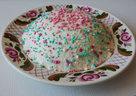 Easter cottage cheese cake, lying on a plate, decorated with colored figurinesの写真素材